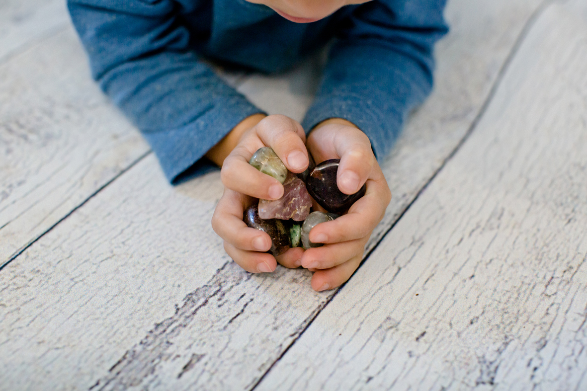 Child holding stones (crystals) in his hands